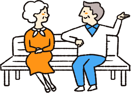 老夫婦が公園のベンチで話をしている